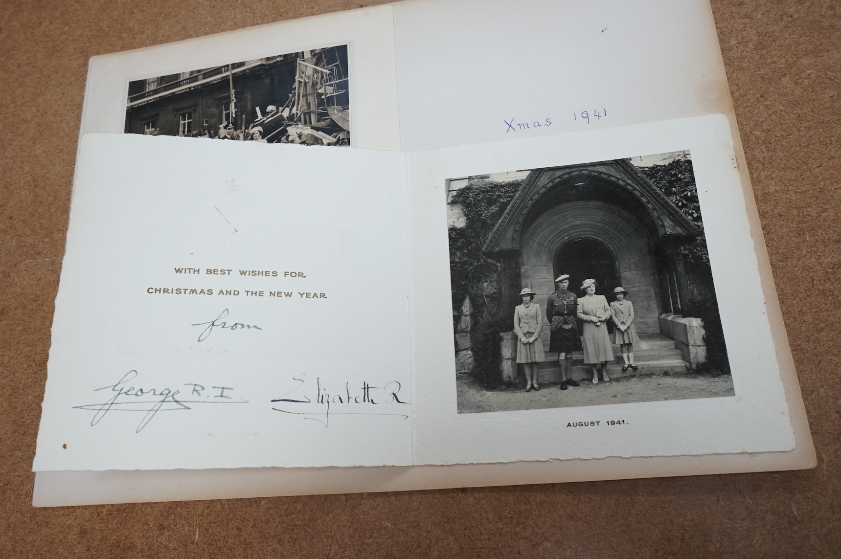 Two Royal Christmas cards; a card for Christmas 1940, the image used being a photograph of HM King George VI and Queen Elizabeth against a backdrop of the bomb damage at Buckingham Palace, dated ‘September 10th 1940’ (un